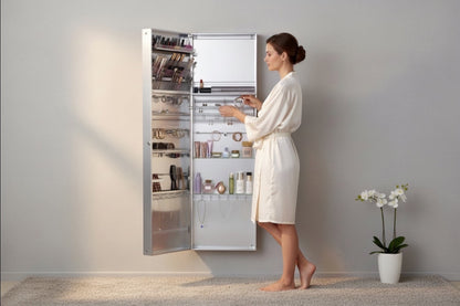 VanitiBox stainless steel makeup and jewelry armoire with mirrored doors, organized with makeup, brushes, necklaces, and rings.